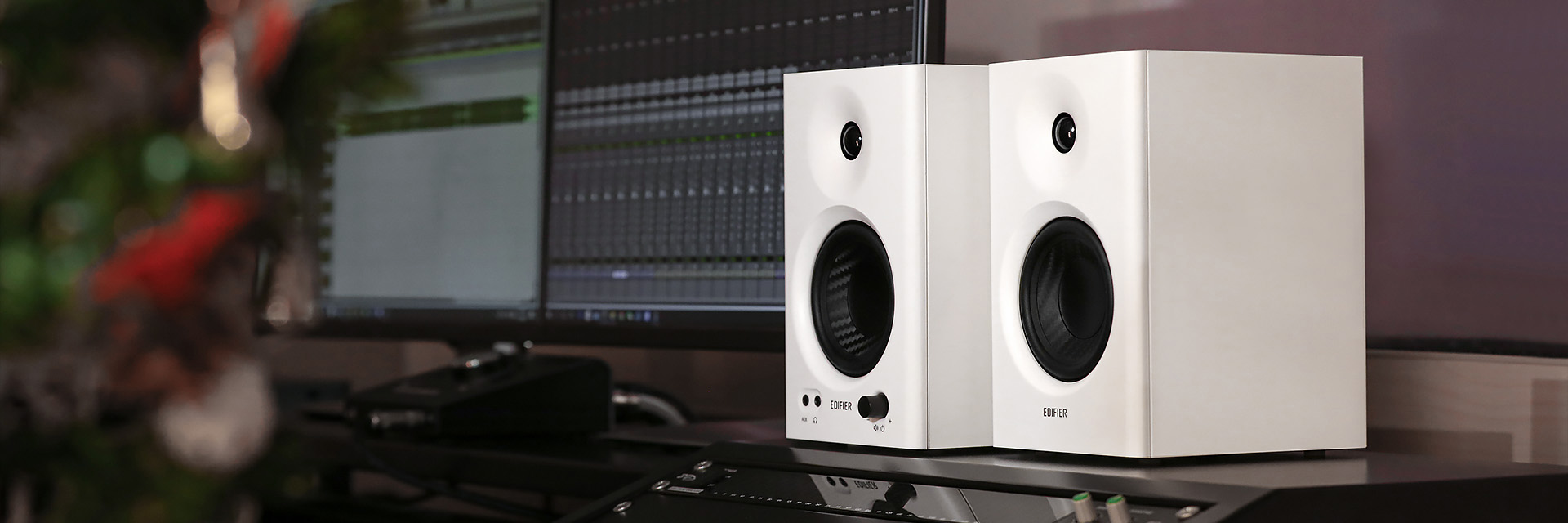 Edifier MR4 Powered Monitor Speakers are on a table with professional music mixing equipment