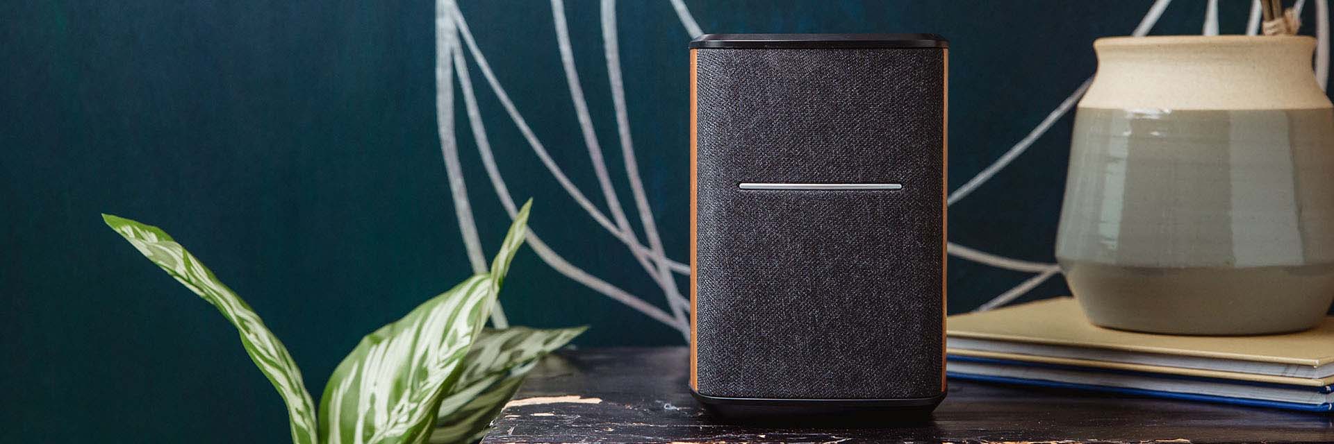 Edifier MS50A Wi-Fi speaker is sitting on a table with pottery and plant